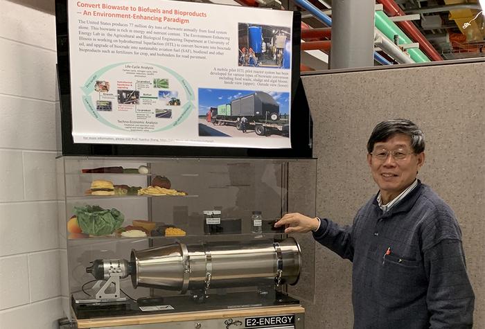 Yuanhui Zhang stands in front of a biowaste recycling project